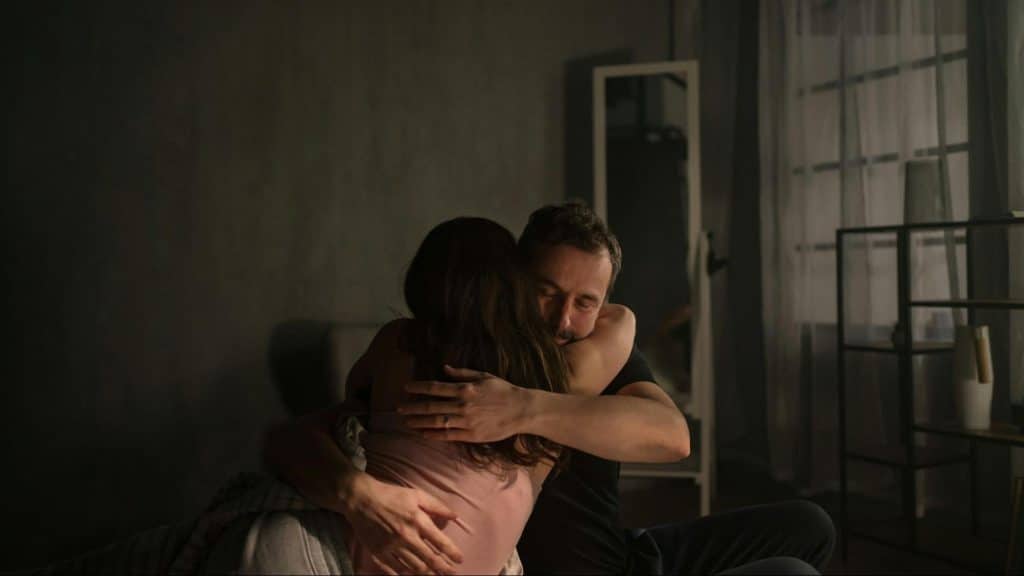 A man hugging a woman