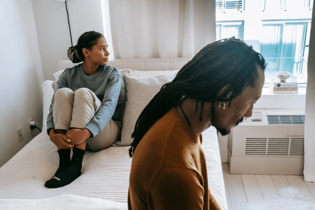 Black couple spending time on bed at home