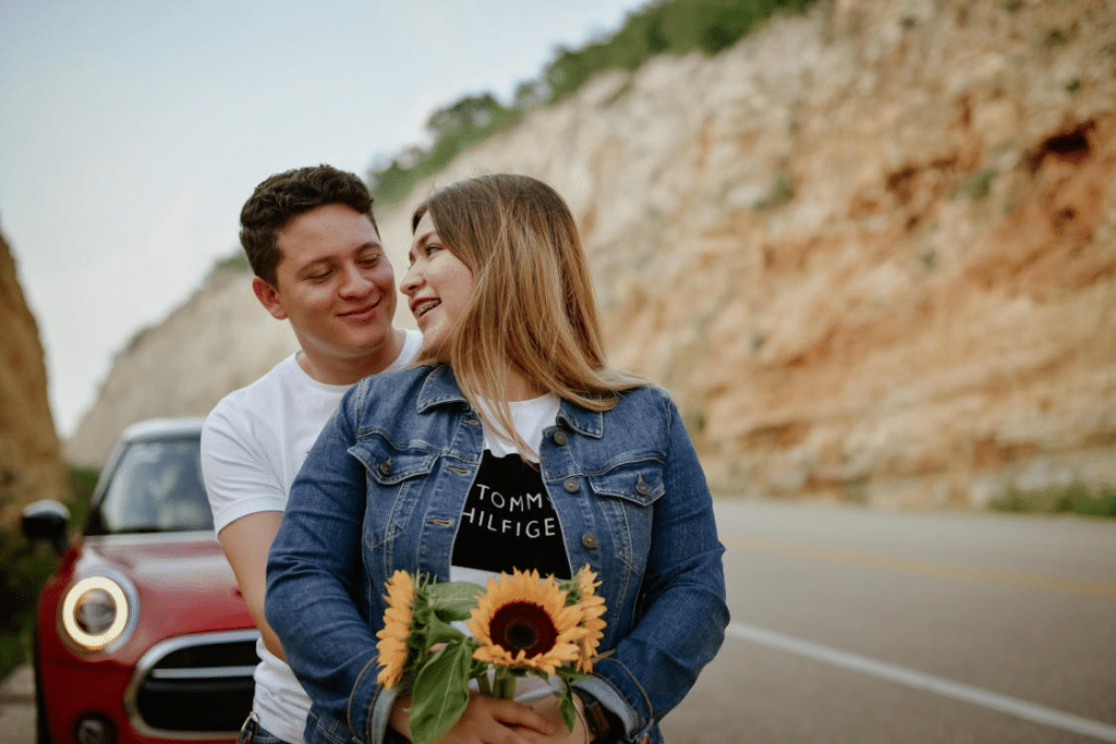 Man surprising girlfriend with flowers