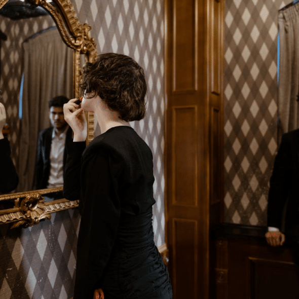 A Woman Looking at the Mirror with a Man
