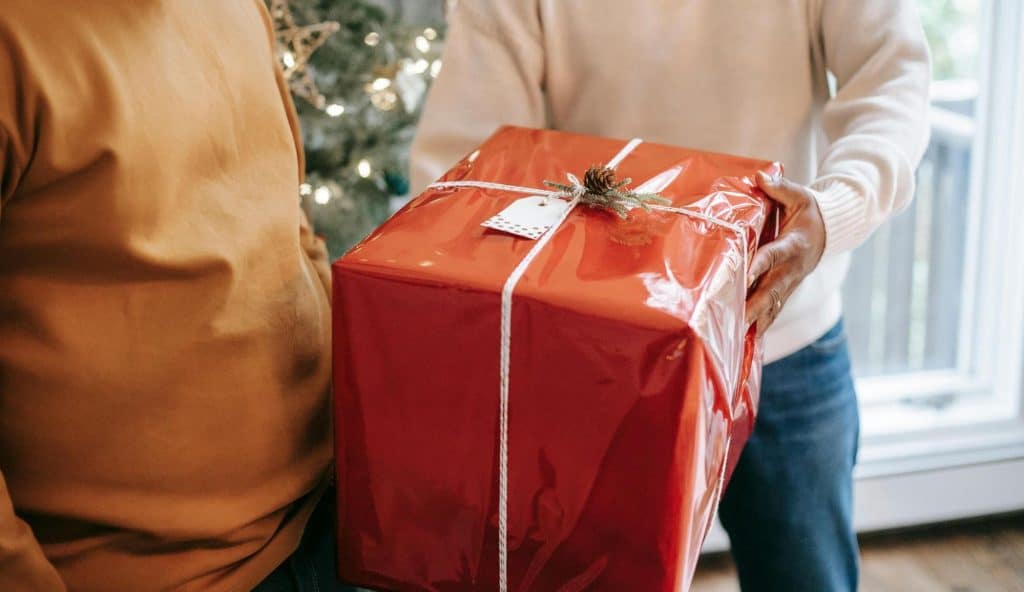 A person giving a gift to another person