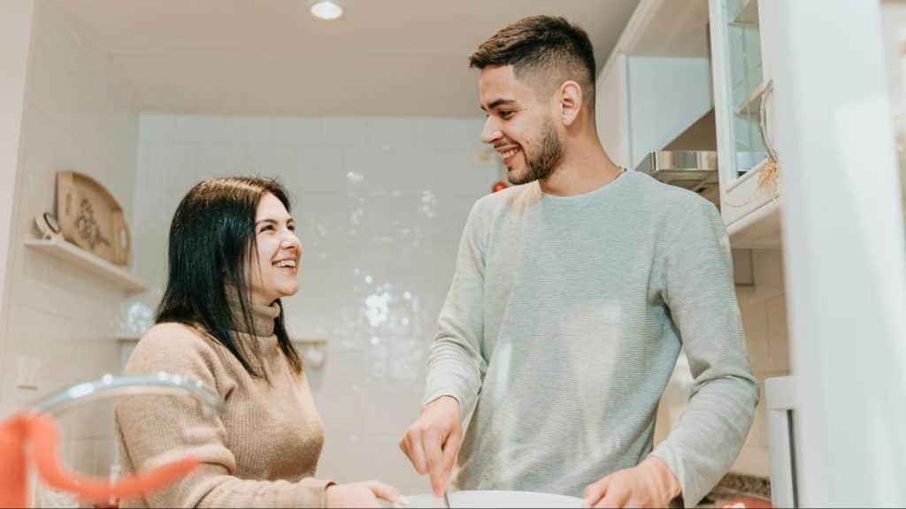 A man and woman at the kitchen having a conversation
