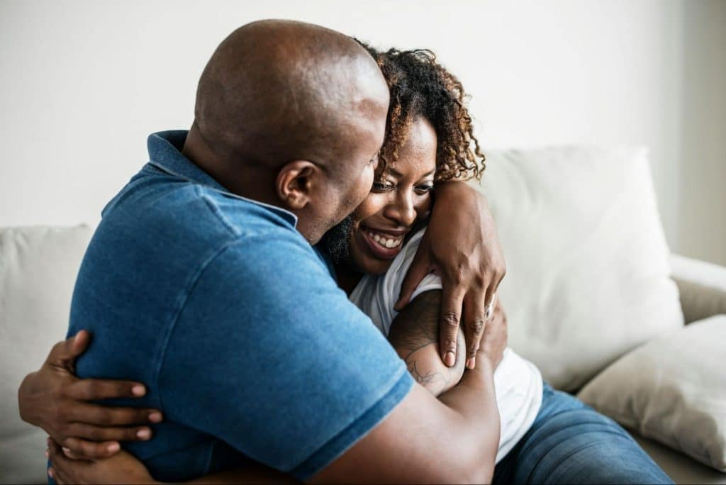 A man hugging a woman