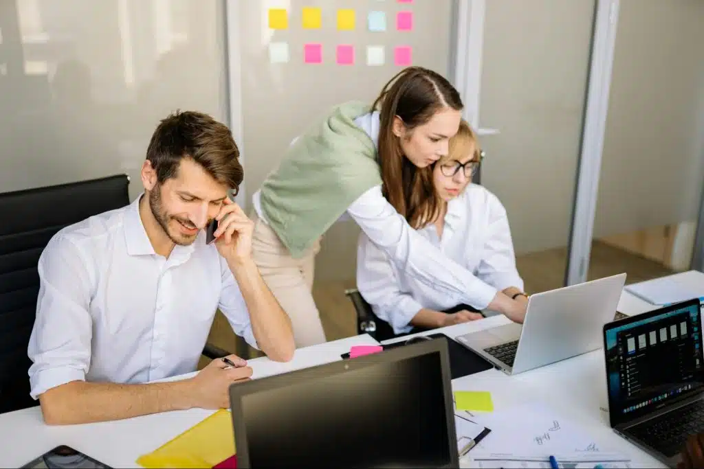 A man talking with someone over the phone instead of working
