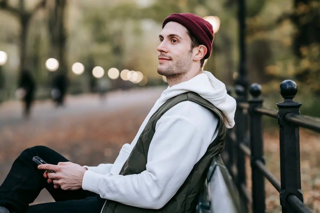 A man sitting on a bench while smiling