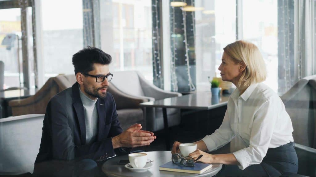 A man explaining to woman