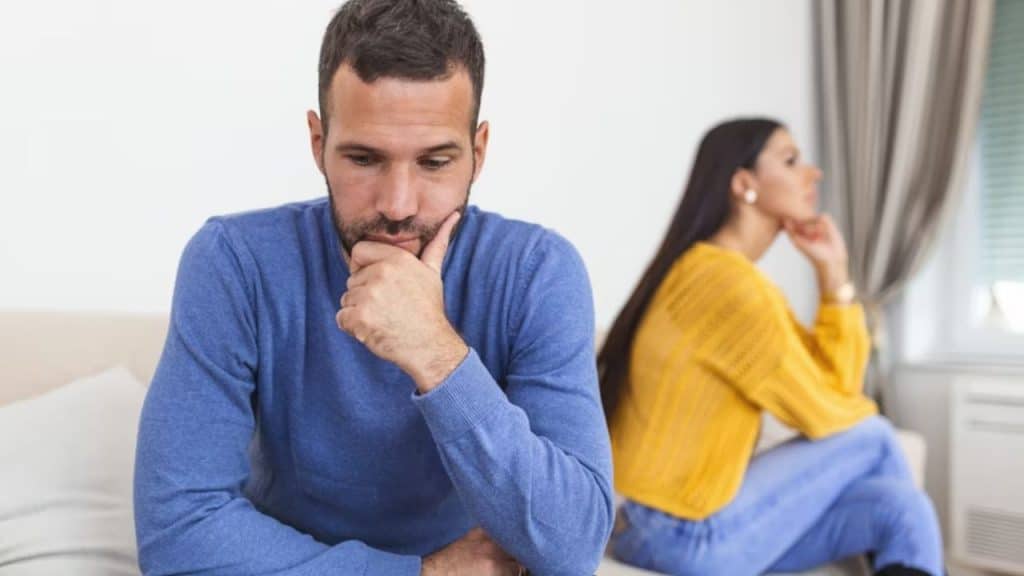 Couple sitting in silence, looking away from each other