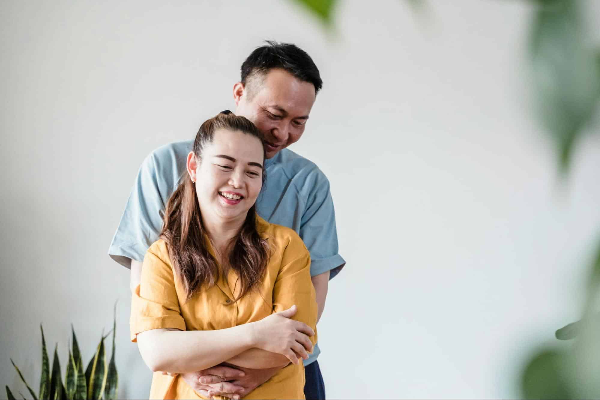 A man hugging a woman