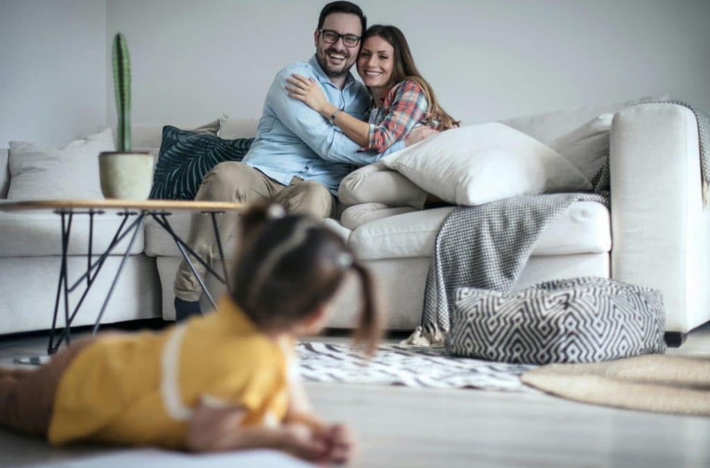 A man and woman looking at their child