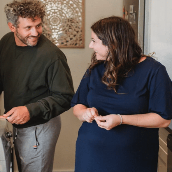 A couple talking in the kitchen