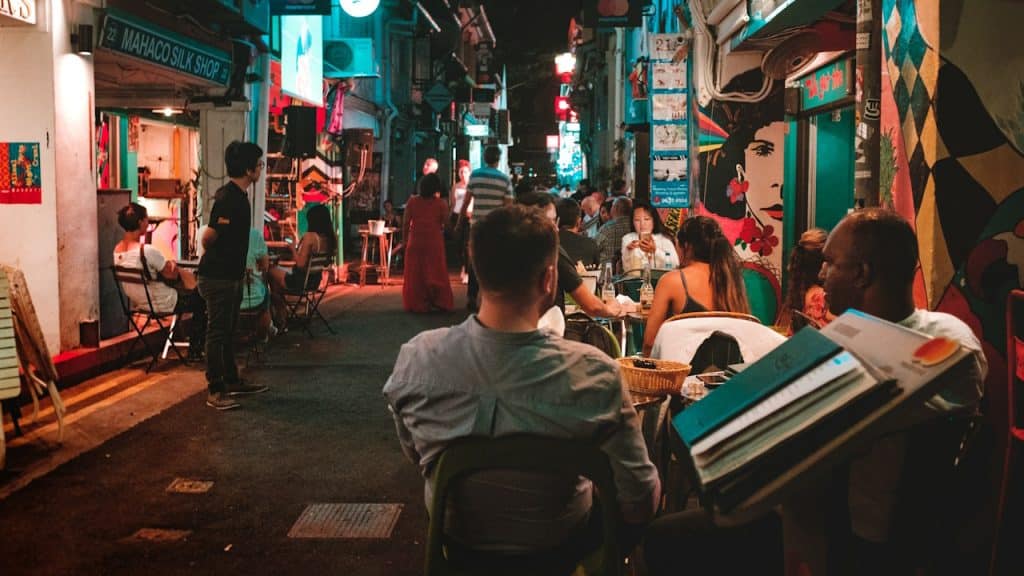 A group of people sitting on the street.