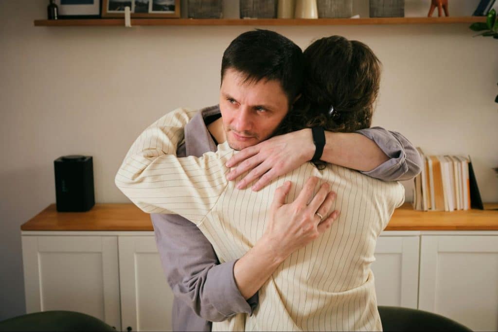 A woman hugging a man