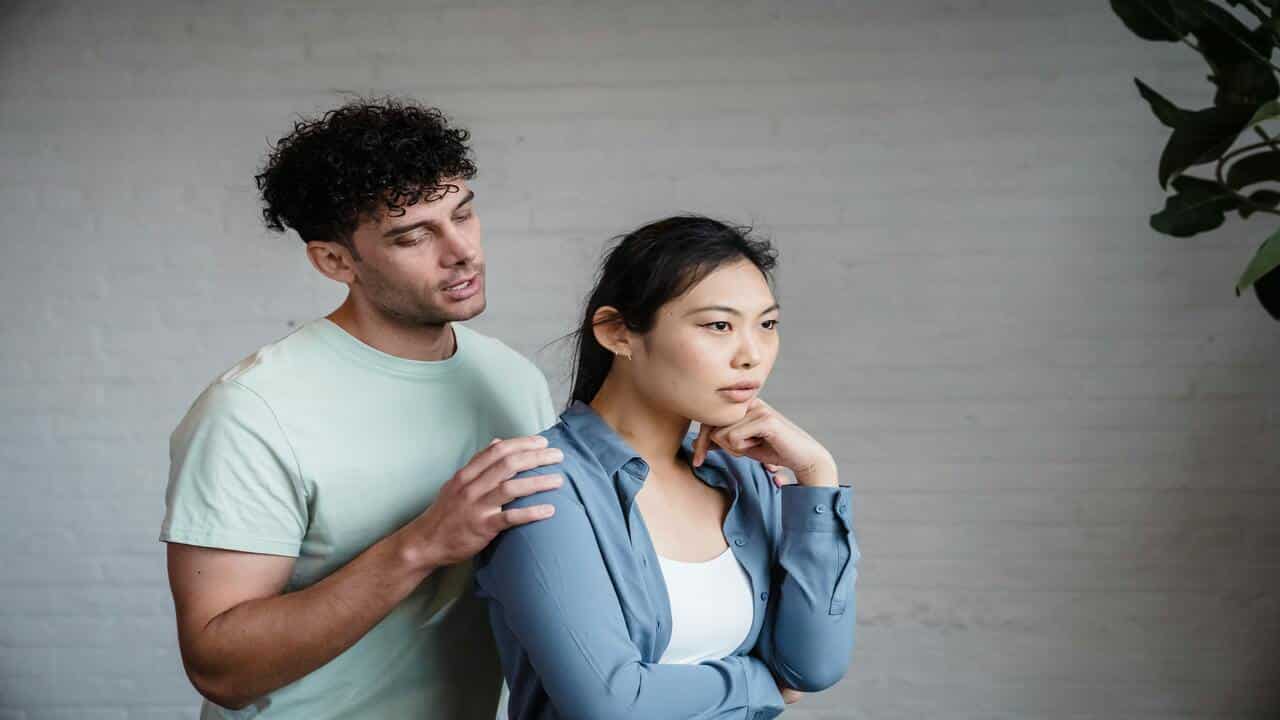 A couple talking indoors 