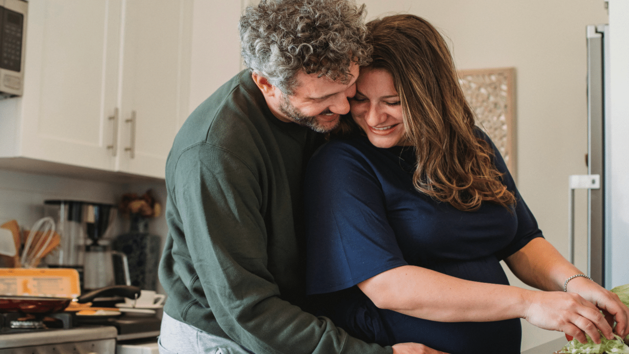 A couple hugging in the kitchen