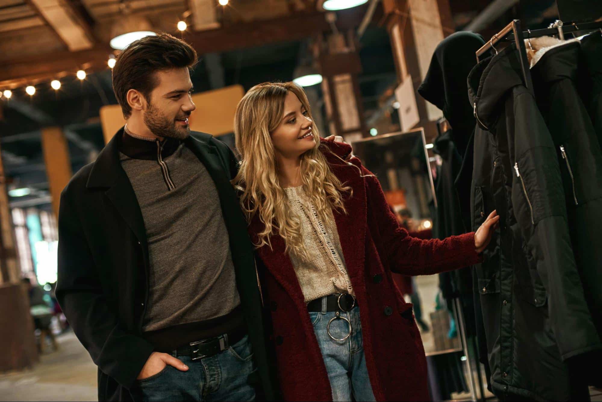 A man and woman checking a coat