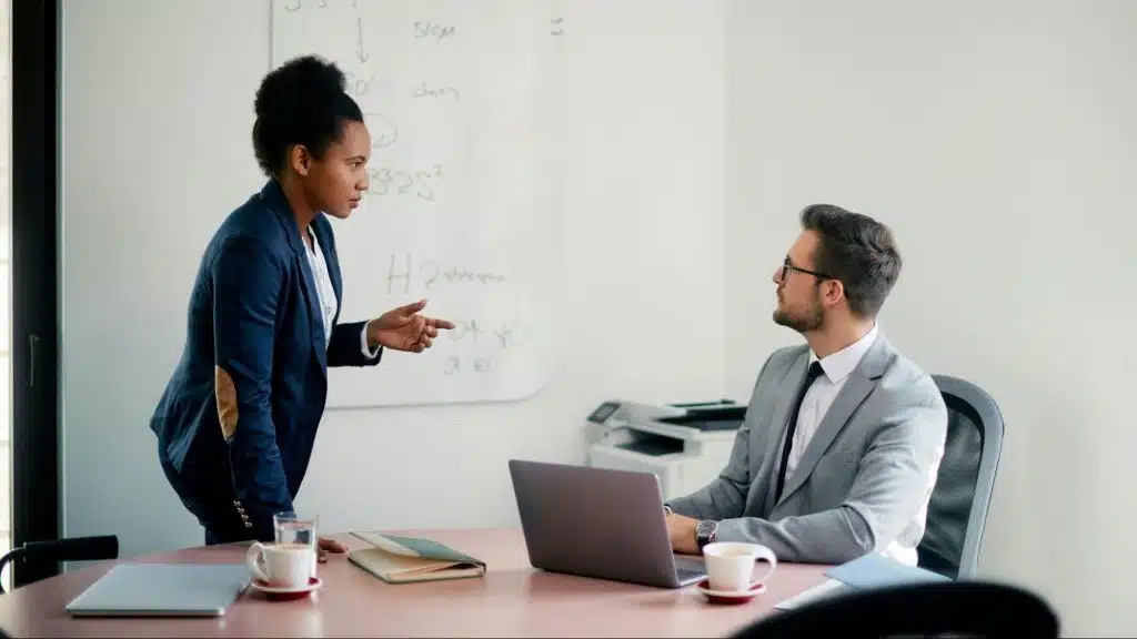 A woman raising her concerns to a man