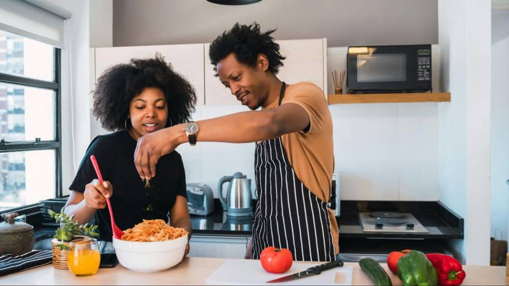 A man and woman having a bond in the kitchen