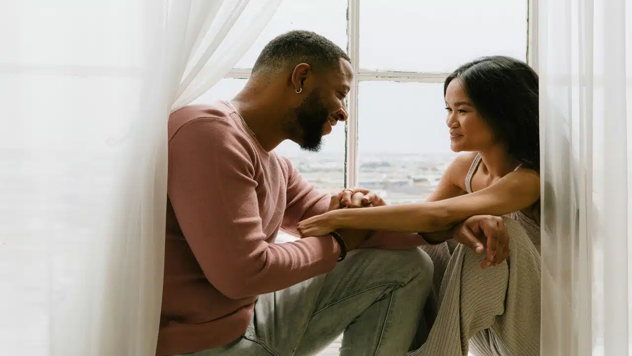 A couple flirting by the window