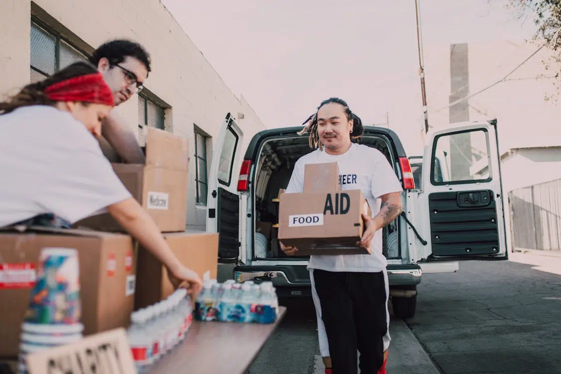 A man giving food aid to a charity