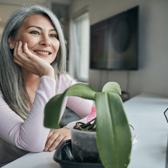 A woman smiling while looking out the window