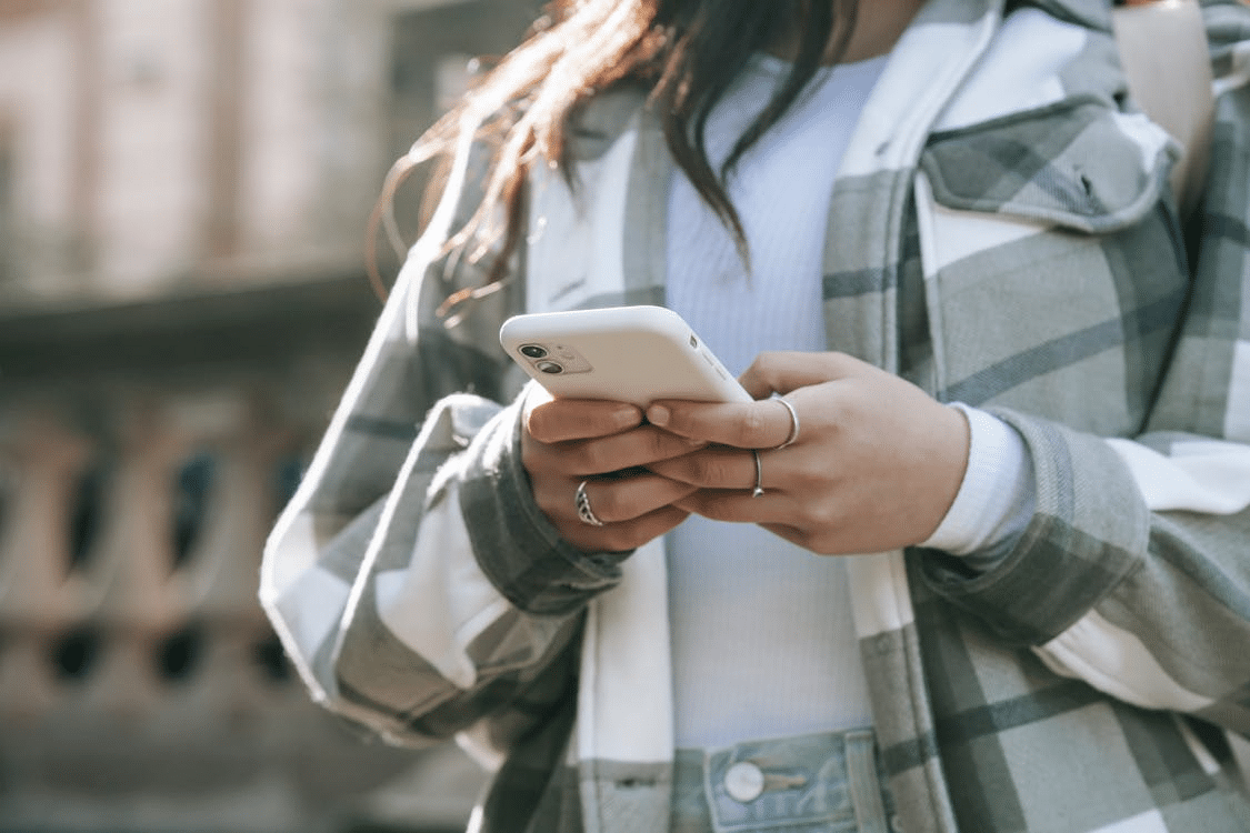 A woman typing on her phone