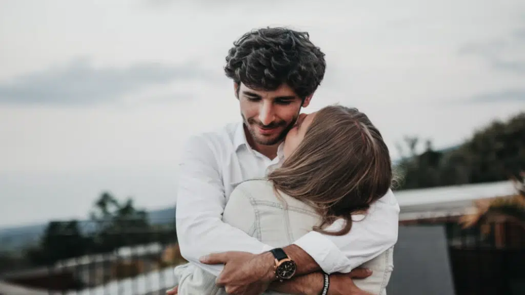 A couple hugging outdoors