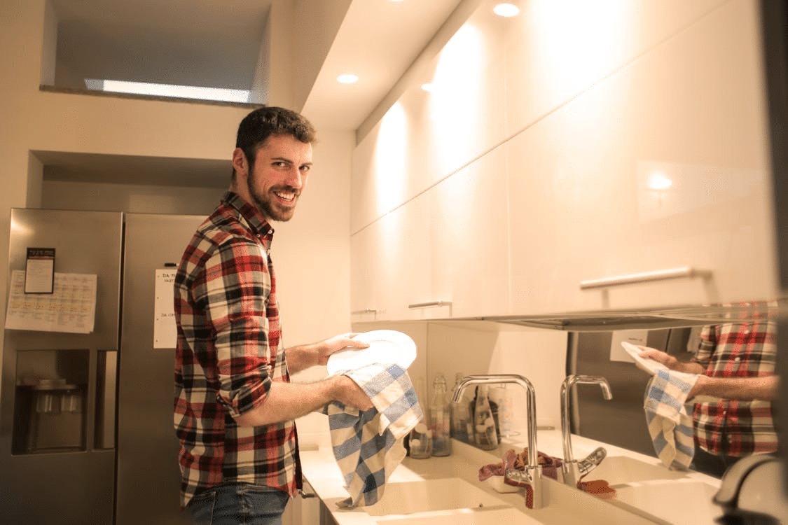 A man wiping the dishes