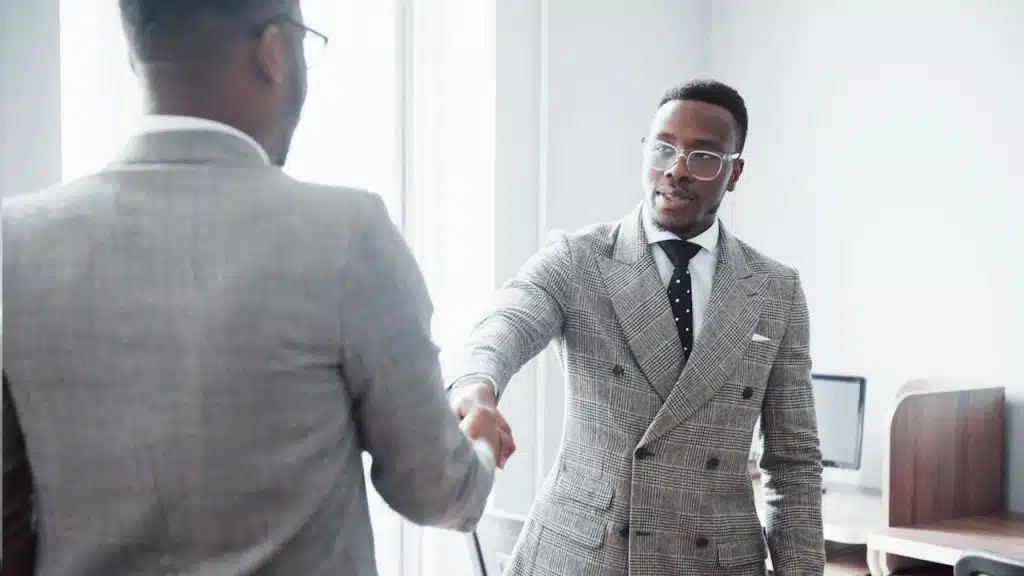 Two handsome, cheerful African American executive businessmen at the workspace office.