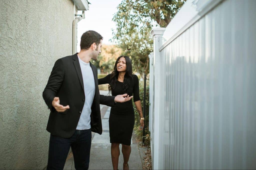 A man and woman arguing while outside