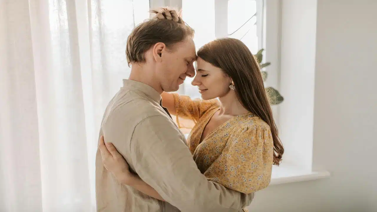 A couple hugging at home
