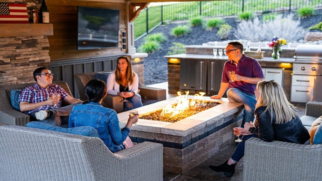 A group of young adults around a fire