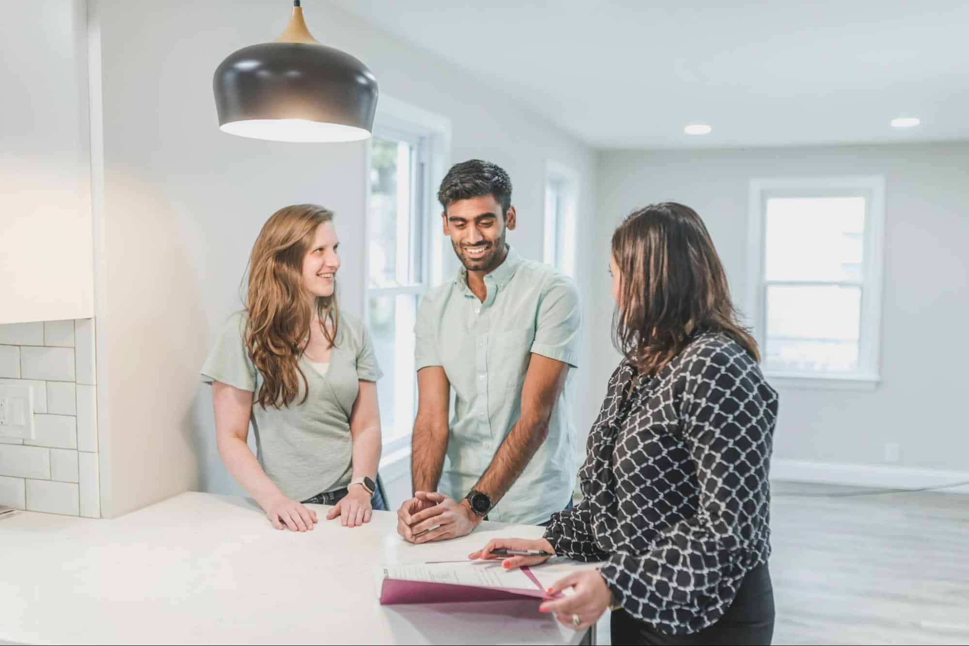 A man and woman having a conversation with an agent