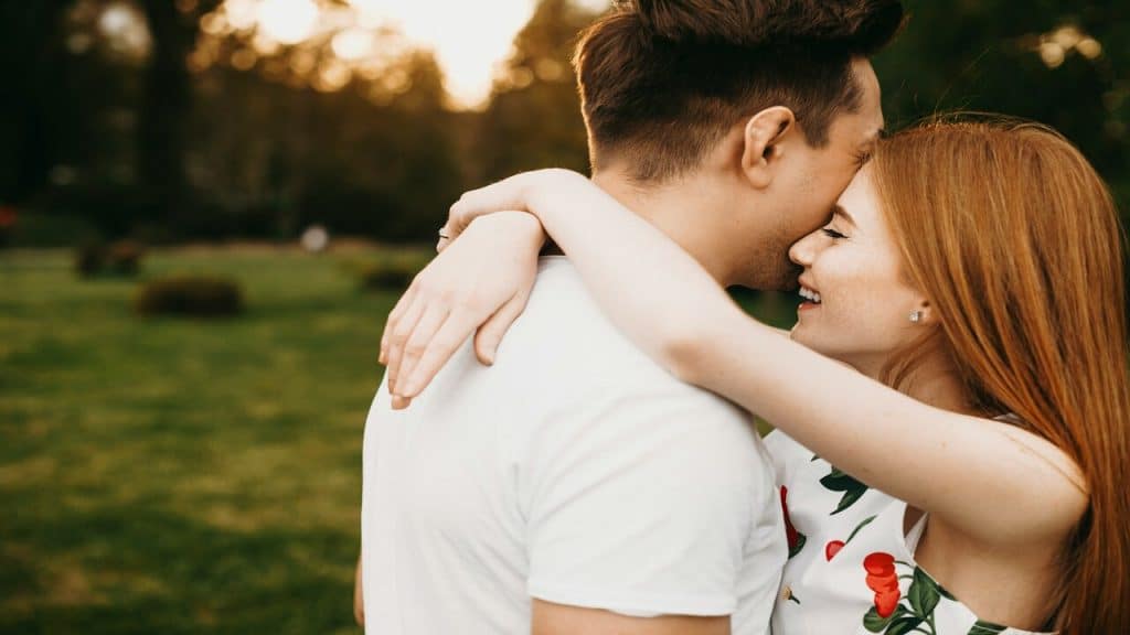 A couple hugging in the garden