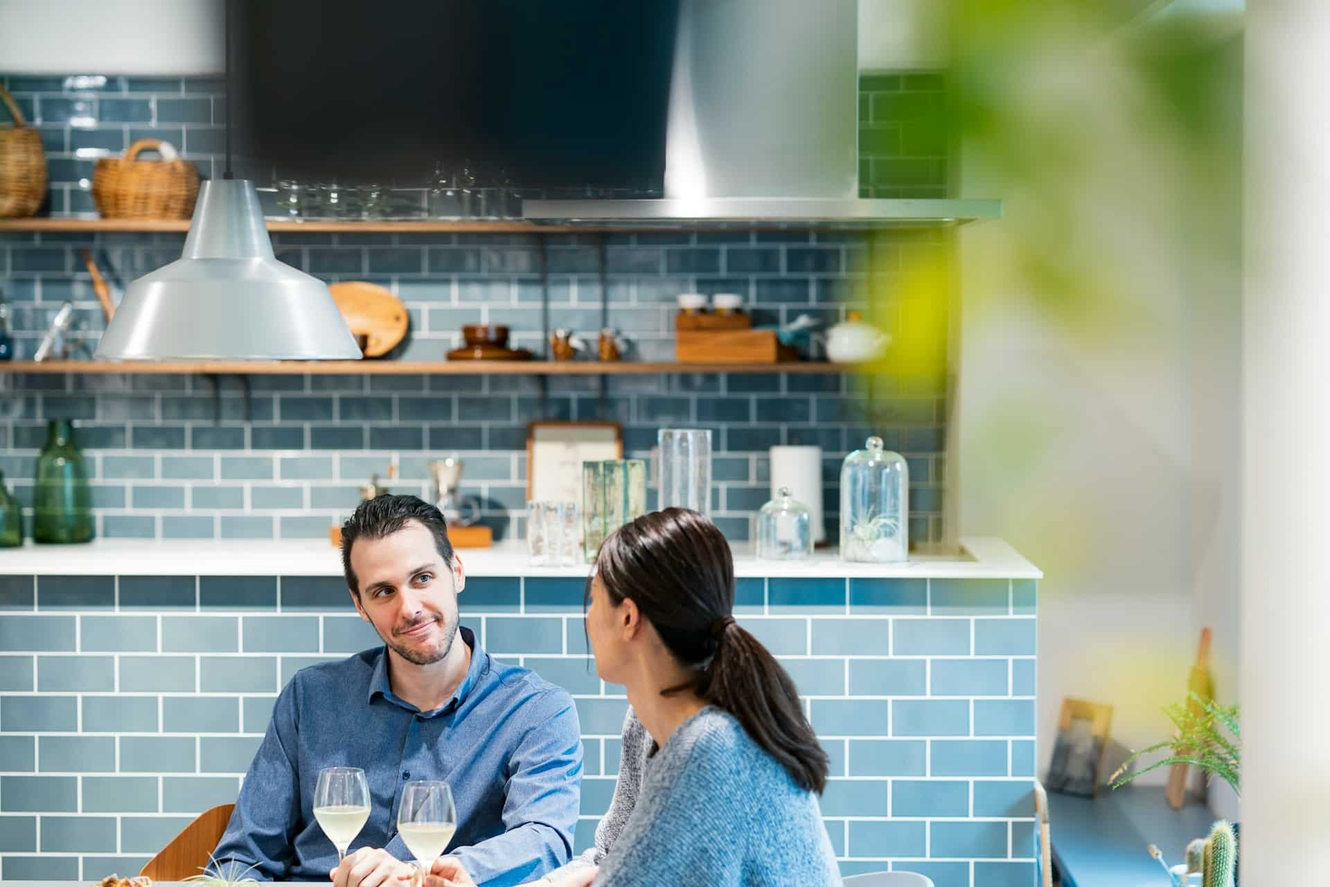 A man looking at the woman while having drinks.