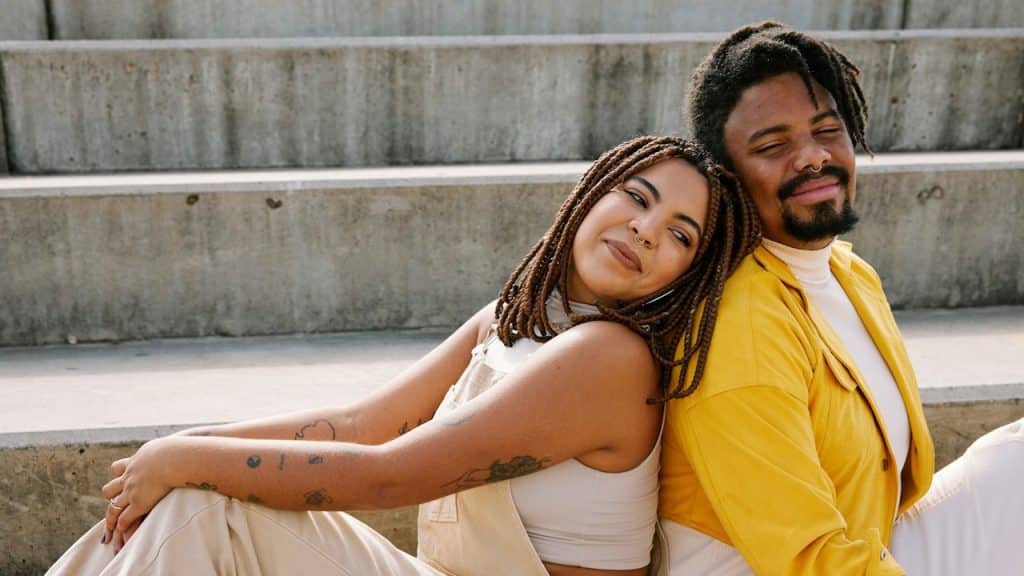 A man and a woman sitting next to each other.