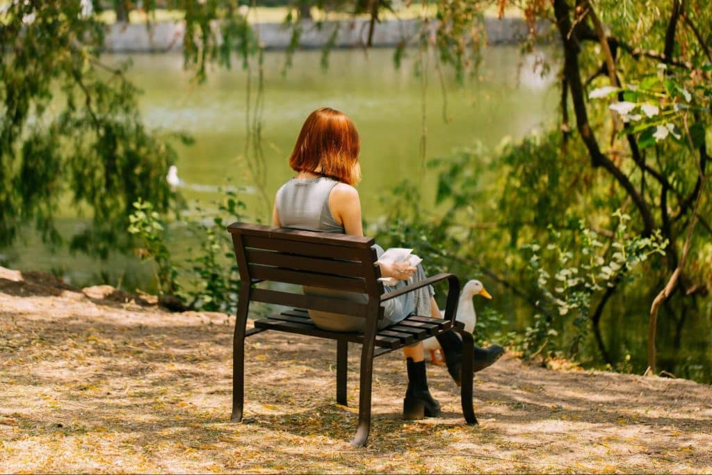 A woman sitting at the bench