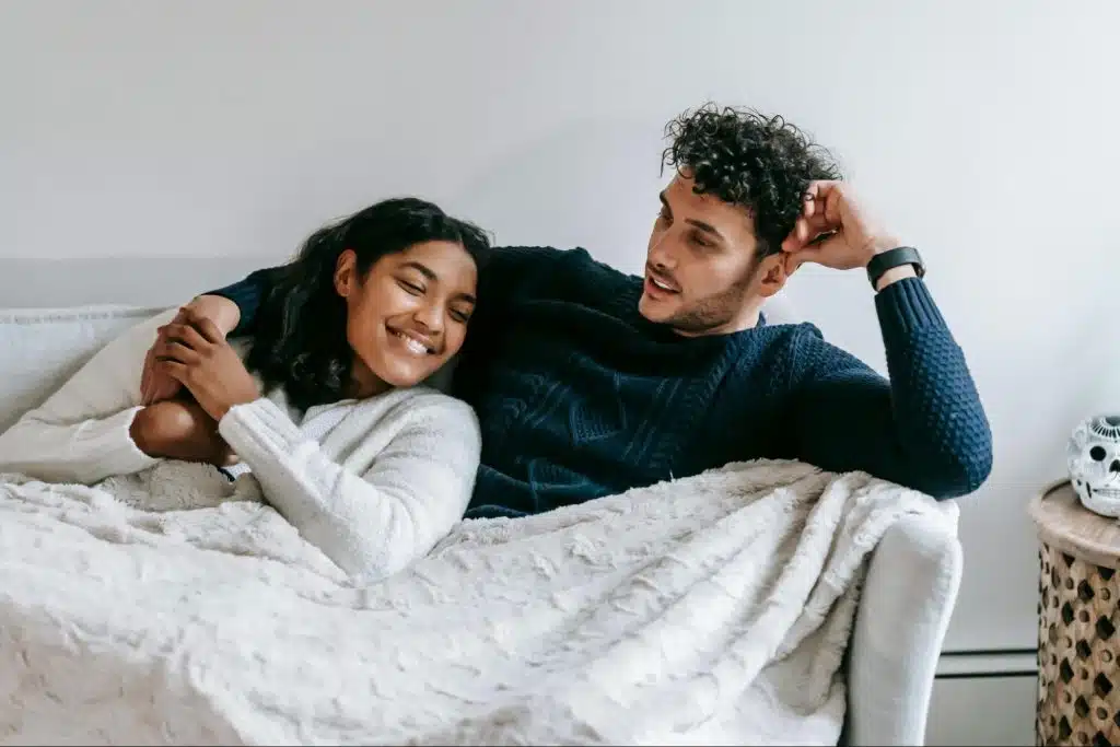 A man and woman at the bed