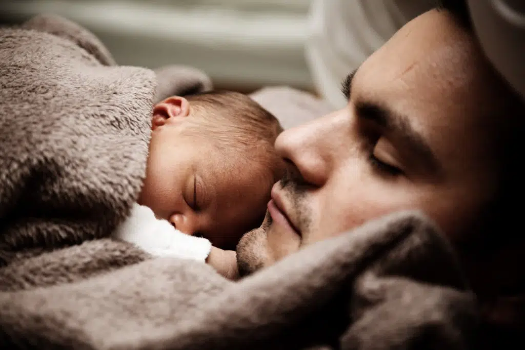 A man holding his newborn baby