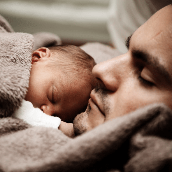 A man holding his newborn baby