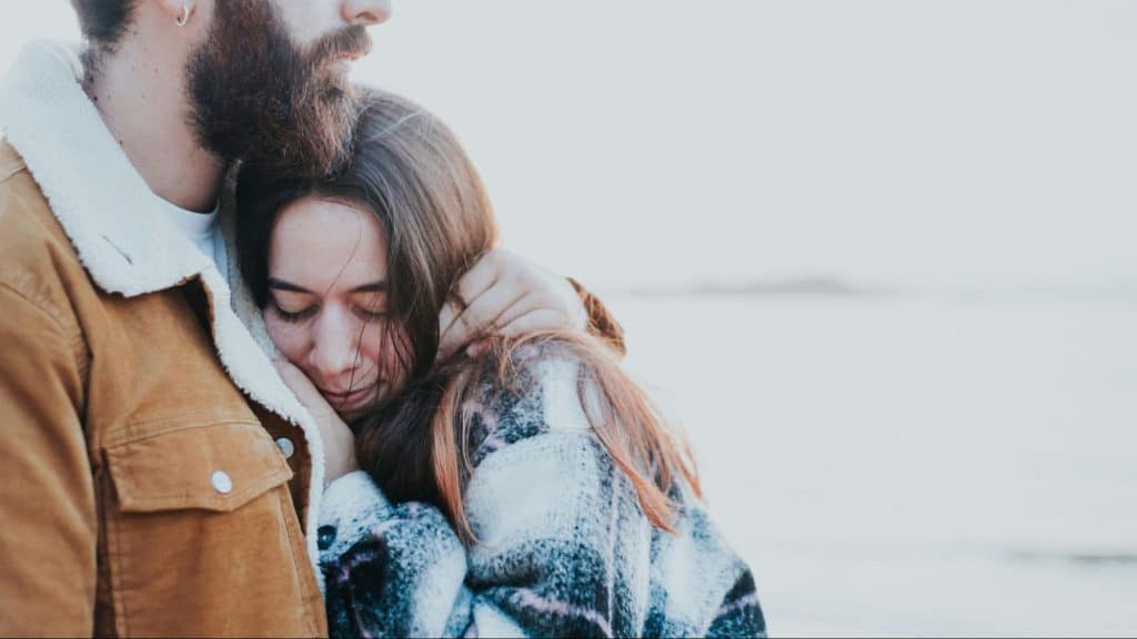 A man hugging a woman