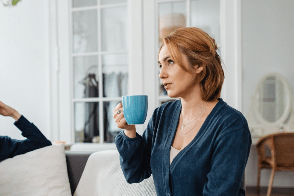 A woman holding a blue mug