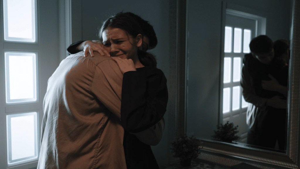 A man hugging his wife while she cries