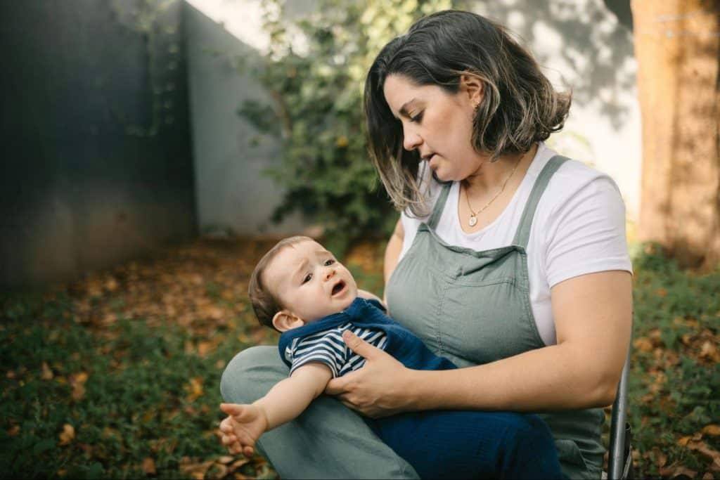 A woman taking care of a crying baby