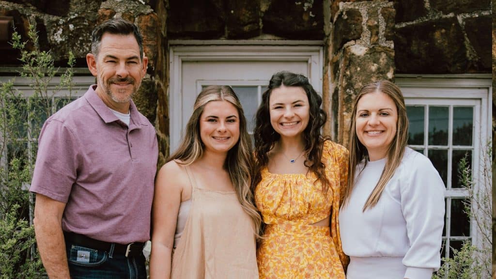 A family posing for a picture and smiling.