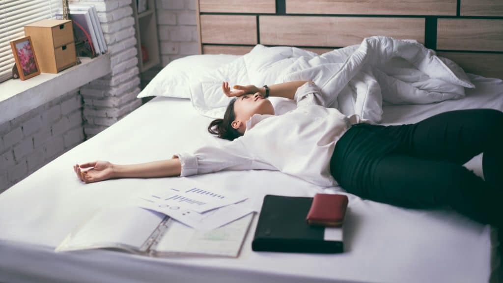 A stressed woman lying on the bed.
