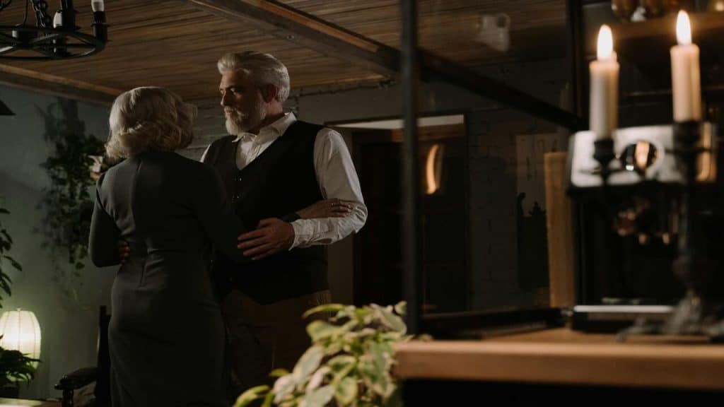 A couple about to hug in the kitchen