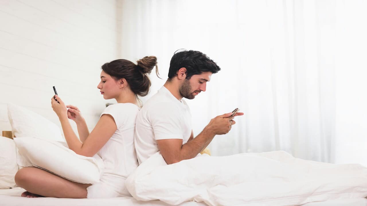 A couple busy with their phones