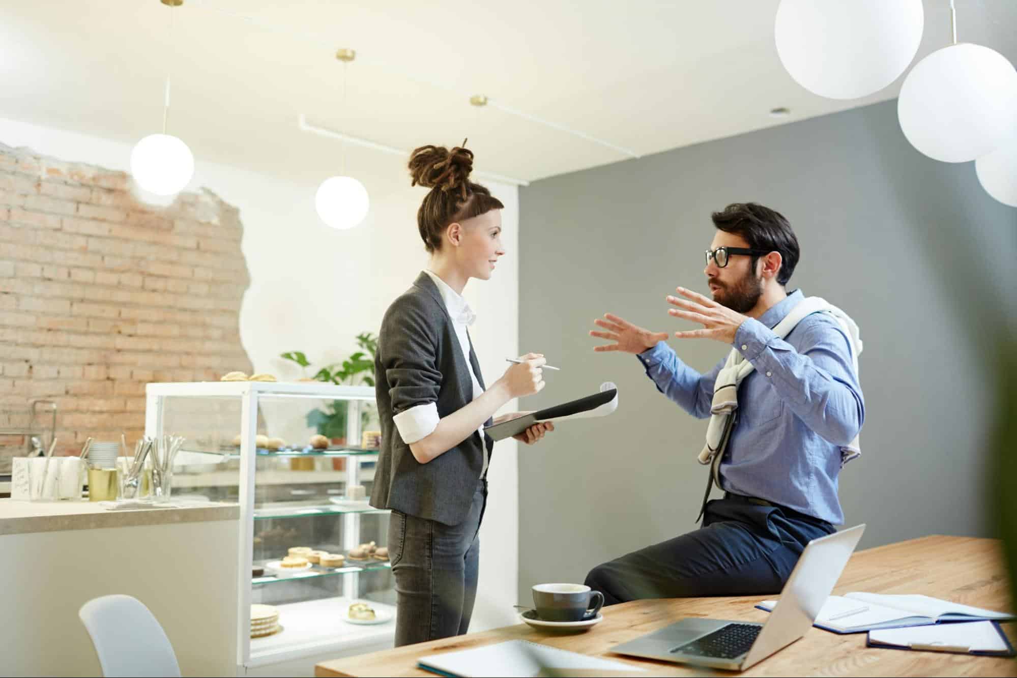 A man and woman talking about work
