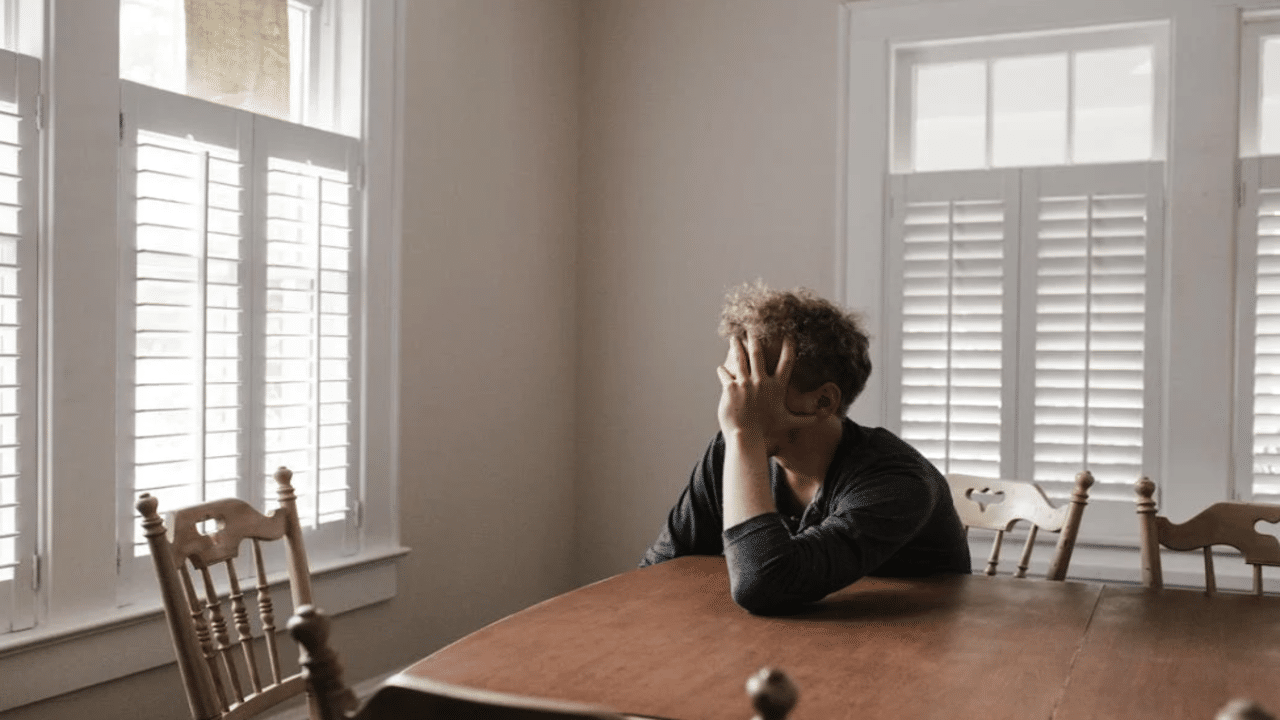 A man looking upset at home