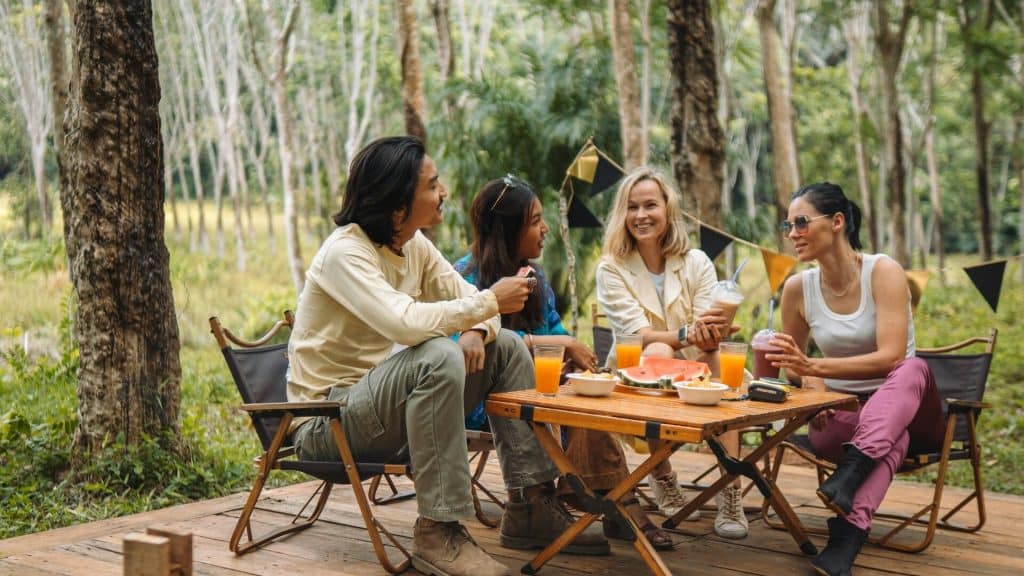 A group of people sitting around a wooden table.